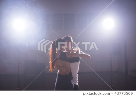 Young couple dancing social danse kizomba or bachata or semba or taraxia in dancing class background 43773509