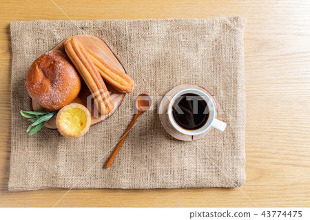 A brunch-style snack consisting of bread and coffee A brunch-style snack consisting of bread and coffee 43774475
