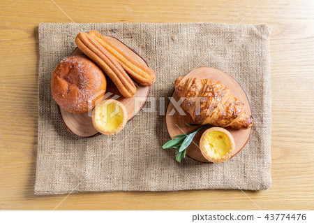 A brunch-style snack consisting of bread and coffee A brunch-style snack consisting of bread and coffee 43774476