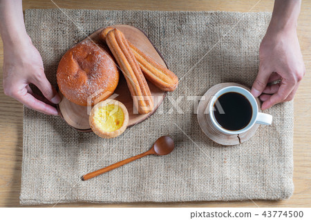 A brunch-style snack consisting of bread and coffee A brunch-style snack consisting of bread and coffee 43774500