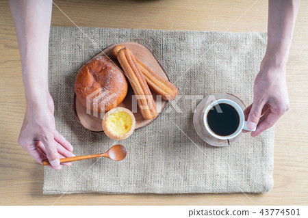 A brunch-style snack consisting of bread and coffee A brunch-style snack consisting of bread and coffee 43774501