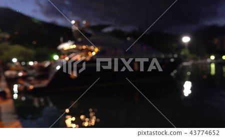 Defocused moored luxury motor yacht at marina at night Defocused moored luxury motor yacht at marina at night 43774652