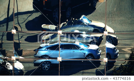 Distorted reflection of city traffic in a modern building facade Distorted reflection of city traffic in a modern building facade 43774816