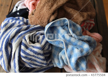 A crumpled wet bath towel, laundry before hanging out to dry A crumpled wet bath towel, laundry before hanging out to dry 43775504