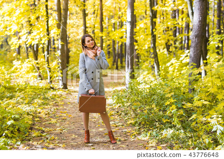 Season, fall and people concept - Portrait of a beautiful young woman in autumn nature 43776648