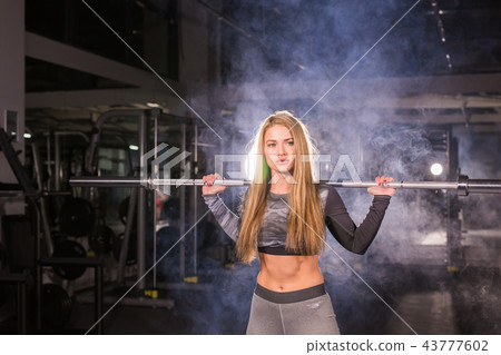 sport, fitness, training and happiness concept - sporty woman with barbell in gym sport, fitness, training and happiness concept - sporty woman with barbell in gym 43777602