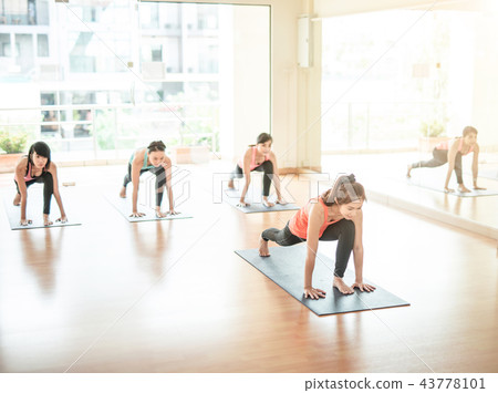 Asian woman doing yoga in yoga studio 43778101