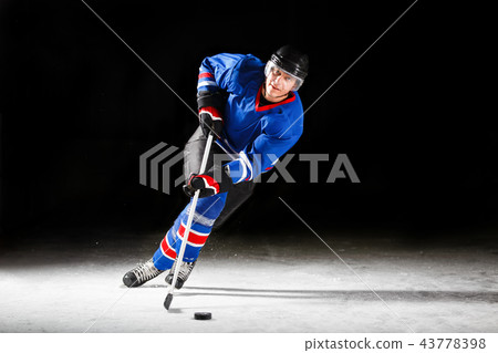 Young hockey player skating on rink in attack 43778398
