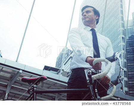 Business man and bicycle walking on street. 43778568