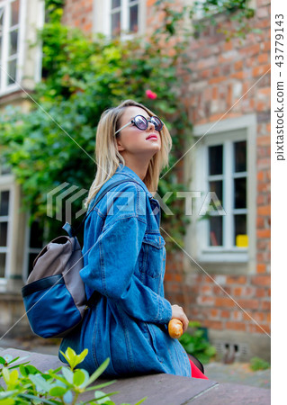 Young lady in jeans jacket on medieval street of Bremen 43779143