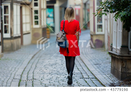 Young lady in dress on medieval street of Bremen Young lady in dress on medieval street of Bremen 43779198