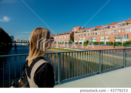 Young girl stay on a bridge with Bremen on background 43779253