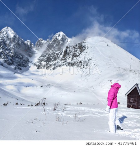 Young woman in pink ski jacket, gloves,  43779461