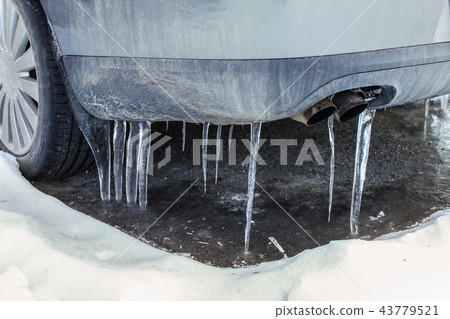 Icicles on exhaust of dirty car unused for time Icicles on exhaust of dirty car unused for time 43779521