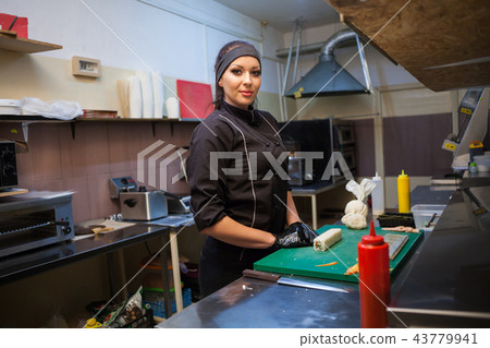 woman Cook prepares sushi on restaurant kitchen 43779941
