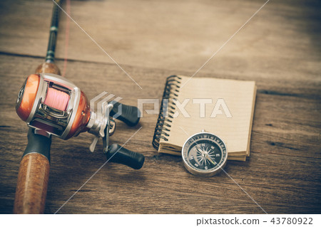 Fishing tackle - Baitcasting Reel, book and compas Fishing tackle - Baitcasting Reel, book and compas 43780922