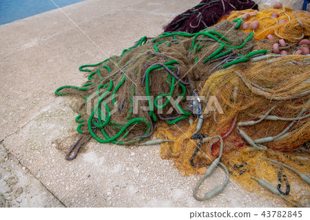 Fishing net on pier piled up, net fishing concept Fishing net on pier piled up, net fishing concept 43782845