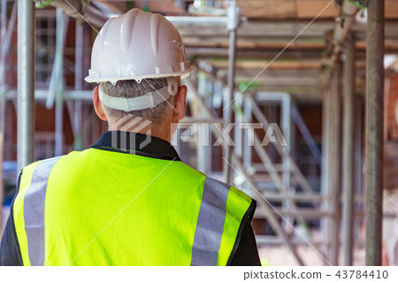 Rear View of Construction Worker on Building Site Rear View of Construction Worker on Building Site 43784410