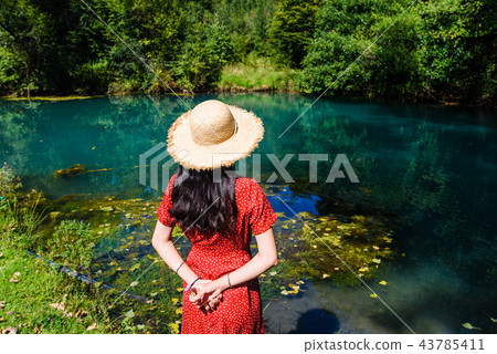 Girl enjoying day outdoors at a natural water well Girl enjoying day outdoors at a natural water well 43785411
