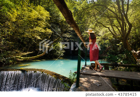 Girl enjoying day outdoors at a natural water well 43785415