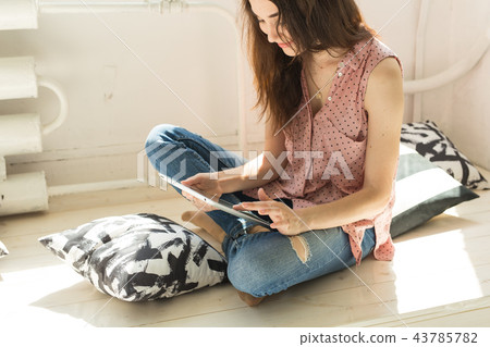 Internet, leisure and technology concept - relaxed young woman using tablet Internet, leisure and technology concept - relaxed young woman using tablet 43785782