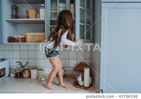 little girl opens the closet 43786198