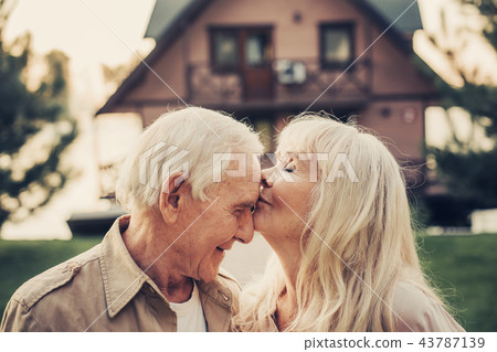 Elderly grey haired woman caressing to man 43787139
