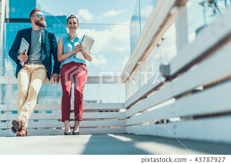 Happy man and girl telling during break 43787927