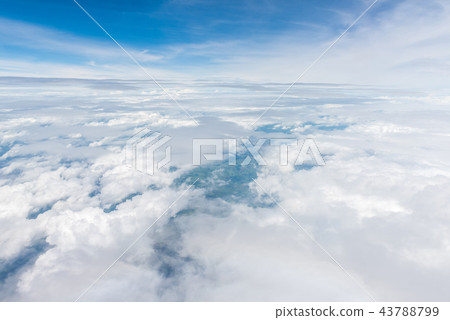 clouds and blue sky through airplane window 43788799