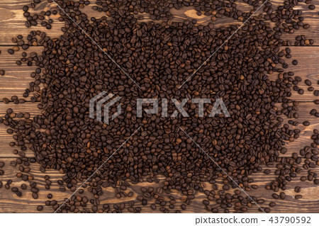 Coffee beans on brown wooden background, coffee texture, top view Coffee beans on brown wooden background, coffee texture, top view 43790592