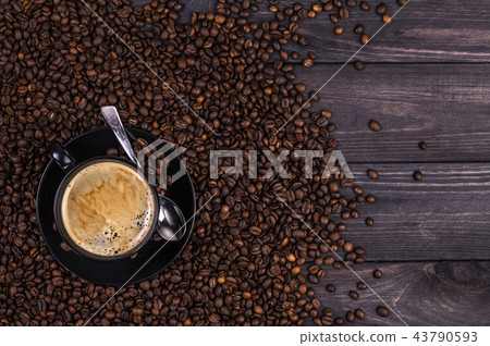 Coffee background, top view with copy space. Coffee cup and coffee beans on black wooden background 43790593