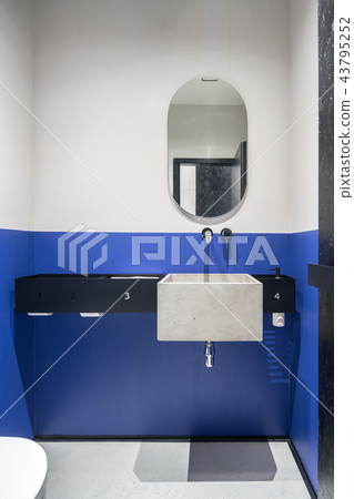 Restroom with multicolor walls and concrete sink Restroom with multicolor walls and concrete sink 43795252
