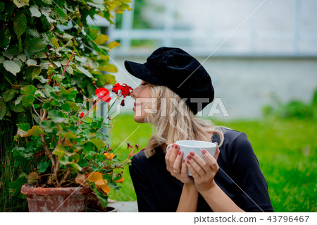 Girl with cup of coffee in garden 43796467
