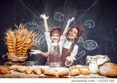 Playful child with mother making dough Playful child with mother making dough 43797190