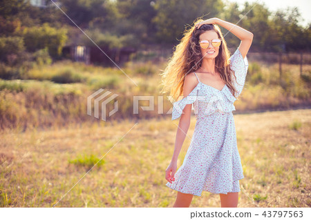 beautiful young woman outdoor on the hill on a summer day beautiful young woman outdoor on the hill on a summer day 43797563