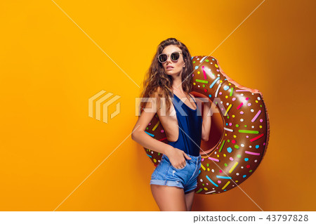 Woman in swimsuit with swim ring 43797828