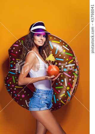 Woman in swimsuit with swim ring Woman in swimsuit with swim ring 43798041
