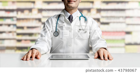 Pharmacist with tablet computer at pharmacy. Pharmacist with tablet computer at pharmacy. 43798067