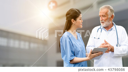 Senior and young doctor working in the hospital. Senior and young doctor working in the hospital. 43798086