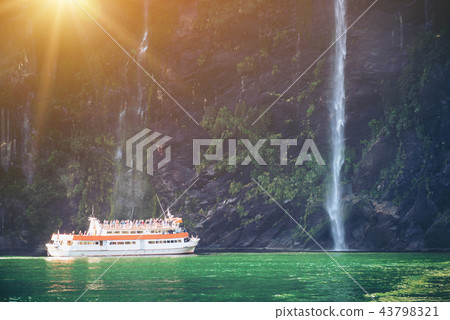 Scenic cruise approaches waterfall, Milford Sound. 43798321