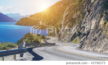 Winding Road along Mountain Cliff and Lake 43798373