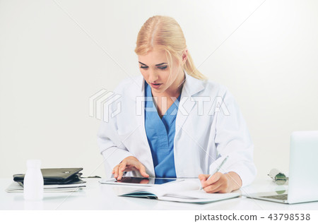 Doctor in hospital working on medical report. 43798538