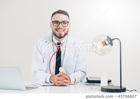 Doctor at office in hospital with laptop computer. 43798607
