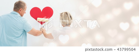 Composite image of couple with color roller and heart 43799504