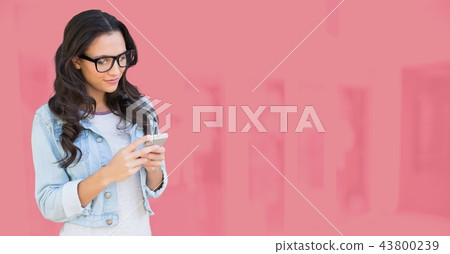 Woman using phone with pink background Woman using phone with pink background 43800239