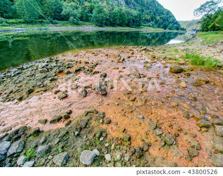 Low water level, empty river inflow. Muddy water 43800526
