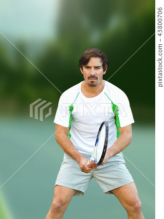 Tennis player man with green background with racket Tennis player man with green background with racket 43800706