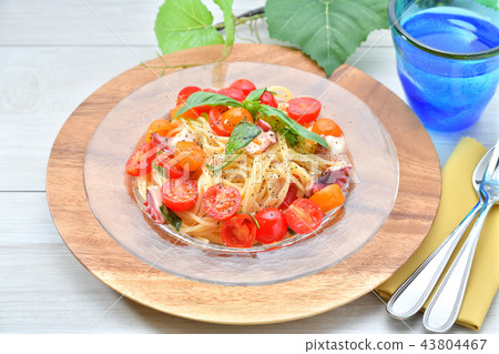 Cool summer "cold pasta". Chilled pasta with cherry tomatoes, colored tomatoes and octopus and anchovies, spaghetti. Cool summer "cold pasta". Chilled pasta with cherry tomatoes, colored tomatoes and octopus and anchovies, spaghetti. 43804467