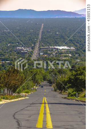 Looking down a street with double yellow lines Looking down a street with double yellow lines 43805153