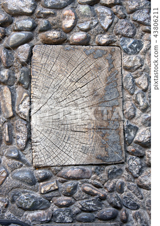 Wooden plank in ancient paving stone 43806211
